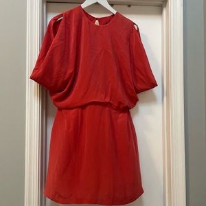 Dark pink loose fitting dress with open back and button detail.